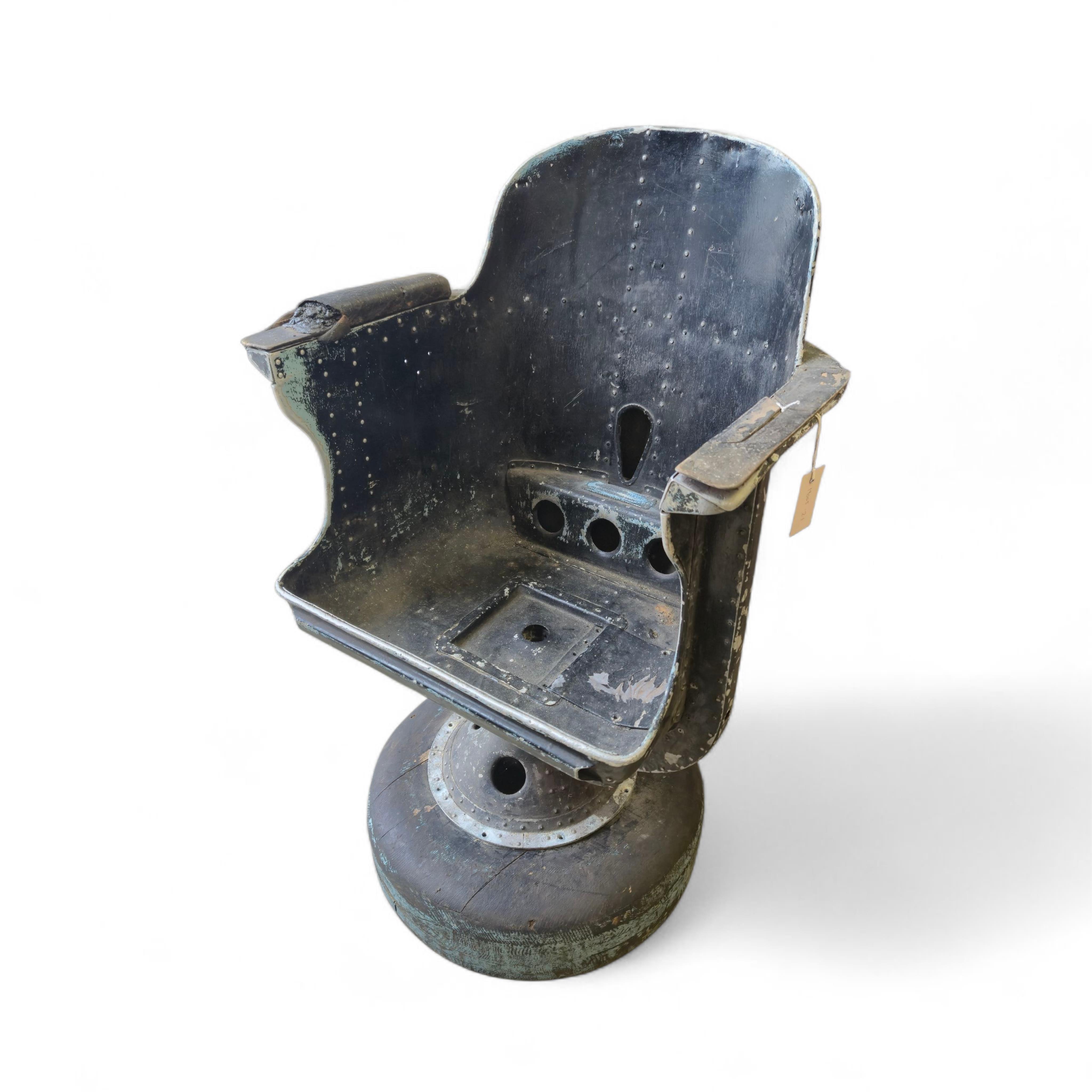 A WWII bomber navigator's chair, with painted aluminium bucket seat and pedestal stand, with a later wooden base, height without base 84cm, the width across the arms 59cm